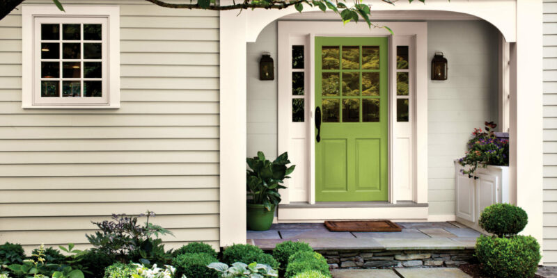 Curb appeal improvements: A well-maintained exterior with a vibrant front door, lush greenery, and updated hardware.